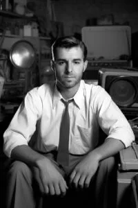 Mann in 50er-Jahre-Kleidung sitzt in Vintage-Aufnahmestudio